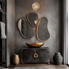 an elegant bathroom with gold accents and mirrors on the wall, along with vases