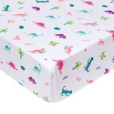 a white sheet with colorful dinosaurs on it