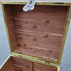 an open wooden box sitting on the ground