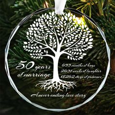 a glass ornament with a tree on it and the words 50 years of marriage