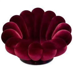 a red flower shaped object sitting on top of a table