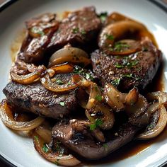 a white plate topped with steak and onions