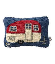 a blue and red pillow with an rv on it