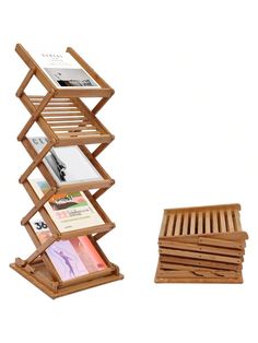 a wooden magazine rack with two magazines on it and a small tray for books in the middle