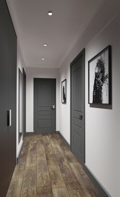 an empty hallway with two doors and pictures on the wall next to eachother