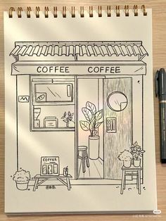 a drawing of a coffee shop next to a pen