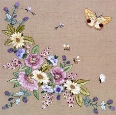 an embroidered piece of cloth with flowers and butterflies