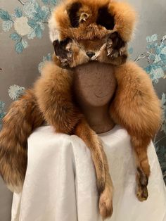 "This, incredibly, wonderful, winter hat has everything going for it. The design points are multiple and such fun! Skin Head hats are known for their attention to details and this red fox, hat does not disappoint. Trapper style at its best; fox face, ear flaps with paws attached, full tail and fold down flaps all around. Suede crown with leather stitching. The inside of the done has a sheered fur lining. This hat looks like it has not been worn. 27 1/2\", 6\" dome" Red Fox, Jackie Brown, Fox Hat, Fox Face, Leather Stitching, Trapper Hats, Tan Suede, Winter Hat, Fox Fur