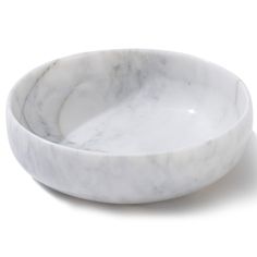 two white marble bowls sitting on top of each other