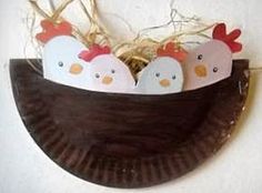 three little chicks in a boat made out of paper plates on top of a brown plate