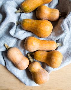 four squash on a cloth in a bowl