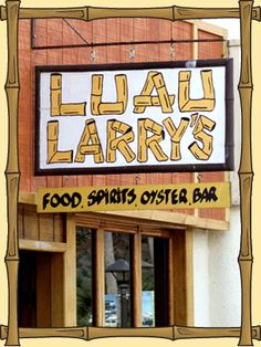 a sign that is on the side of a building saying lauau lary's food spirits oyster bar