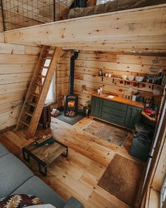 a living room filled with furniture and a fire place in the middle of a loft