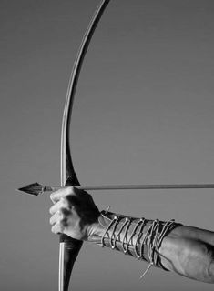 black and white photograph of a person holding an arrow