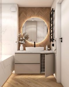 a bathroom with a round mirror above the sink and wooden flooring on the walls