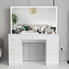 a white desk with a mirror above it