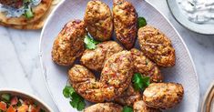 meatballs and pita breads on a plate with tzatzkah