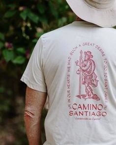 "Our Medieval Wanderer tee draws inspiration from a French prayer & song book, published in 1718, intended for pilgrims venturing to Santiago de Compostela.  This ultra-soft, unisex t-shirt showcases an authentic woodcut illustration extracted directly from the antique text. Encircling the medieval pilgrim is a quote from the book, \"Au couer avions fi grand defir D'aller a' Saint Jacques.\" This translates, \"In our hearts, we had such a great desire to go to Saint James,\" and infuses this shirt with a sense of quest & longing. Aside from being the softest shirts in your closet, our QuickDry tees are made of a unique tri-blend fabric (50% poly, 25% rayon jersey, 25% Airlume cotton). This means they dry 50% faster than traditional cotton tees. * This fabric has been pre-laundered to reduc Medieval White Shirt, Middle Ages Shirt, Hikinh Shirt, White Screen Print T-shirt For Adventure, Camino Trail Spain, Woodcut Illustration, Hiking Tshirt, Saint James, Cotton Tee