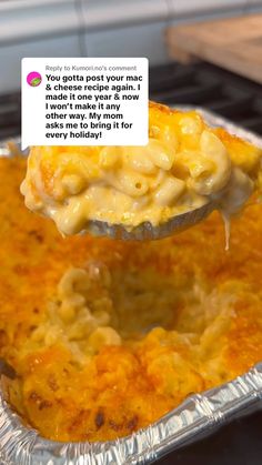 a spoon full of macaroni and cheese being held up