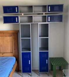 a bedroom with blue lockers next to a bed