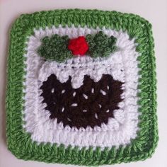 a crocheted square with a christmas decoration on it