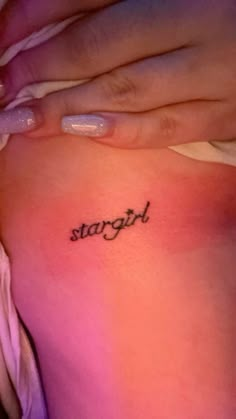 a woman's stomach with the word strength tattooed on it