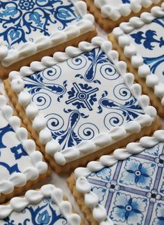 blue and white decorated cookies sitting on top of a table