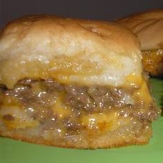 two cheeseburger sliders on a green plate