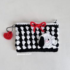 a black and white crochet purse with a dog on it