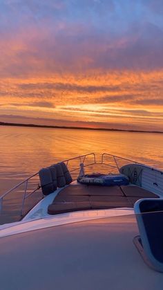 the sun is setting over the water on a boat in the middle of the ocean