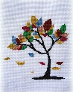 a cross stitch tree with leaves on it