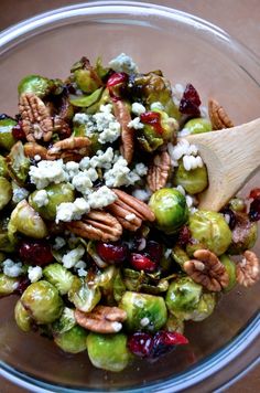 brussel sprouts with walnuts, cranberries and feta cheese in a glass bowl