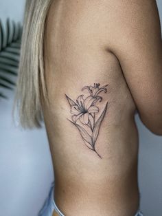 a woman with a tattoo on her stomach has a flower tattooed on her right side