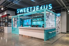 the interior of a store with blue and white decor on it's walls, including an ice cream kiosk