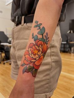 a person with a flower tattoo on their arm