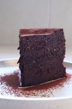 a piece of chocolate cake sitting on top of a white plate