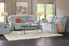 a living room with two recliners and a coffee table in front of the couch