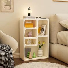 a living room with a couch, chair and book shelf