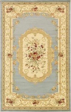 a blue and beige rug with an ornate border in the shape of a flower arrangement