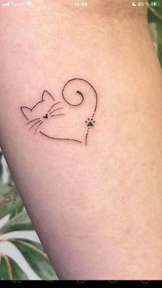 a small cat tattoo on the left thigh and right leg, with an outline of a cat's head