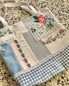 a blue and white tote bag sitting on top of a counter next to a rug