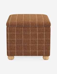 the footstool is made out of wood and has a brown plaid pattern on it