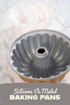 a metal baking pan sitting on top of a counter next to a cupcake tin