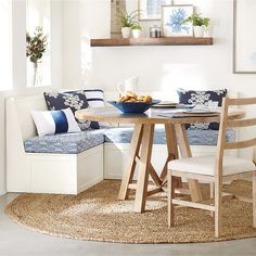 a kitchen table with two chairs and a bench