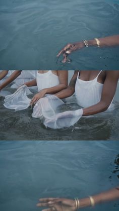 two women in white swimsuits floating in the water with their hands out to each other