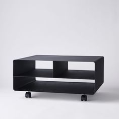 a black table sitting on top of a white floor