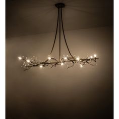 a chandelier with lights hanging from it's sides in a dark room