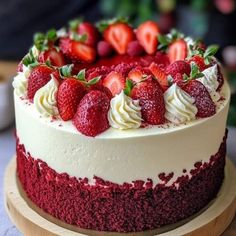 there is a cake with strawberries on the top and white frosting around it