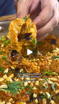 a person is dipping some food into a bowl