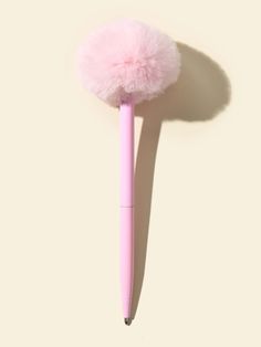 a pink pen with a fluffy ball on it